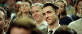 Movie still from “The Theory of Everything” (2014), directed by James Marsh – A person wearing a suit and tie; Close Up shot, Over the shoulder angle