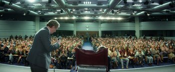 Movie still from “The Theory of Everything” (2014), directed by James Marsh – A large crowd of people sitting in front of an audience; Wide shot, High angle