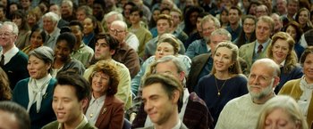 Movie still from “The Theory of Everything” (2014), directed by James Marsh – A group of people sitting in a room; Medium shot, High angle