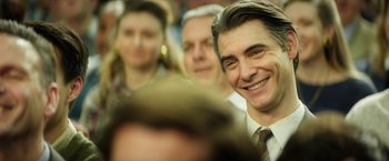 Movie still from “The Theory of Everything” (2014), directed by James Marsh – A group of people sitting in a room; Close Up shot, Over the shoulder angle