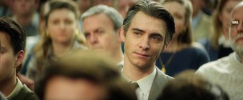 Movie still from “The Theory of Everything” (2014), directed by James Marsh – A man in a suit and a tie; Close Up shot, Over the shoulder angle