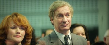 Movie still from “The Theory of Everything” (2014), directed by James Marsh – A person wearing a suit and tie; Close Up shot, Over the shoulder angle