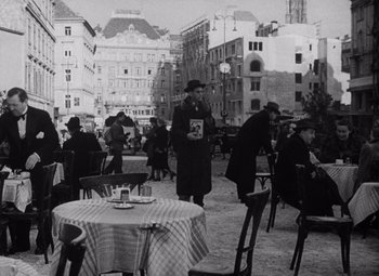Movie still from “The Third Man” (1949), directed by Carol Reed – A black and white photo of people sitting at tables; Wide shot, High angle