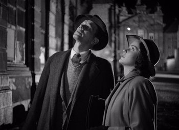 Movie still from “The Third Man” (1949), directed by Carol Reed – A man and a woman standing next to each other; Medium shot, Low angle