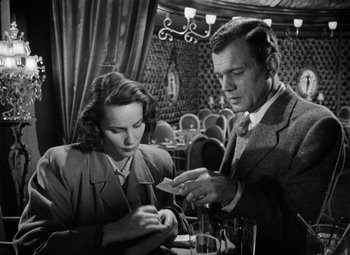 Movie still from “The Third Man” (1949), directed by Carol Reed – A man and a woman sitting at a table in a restaurant; Medium shot, Low angle