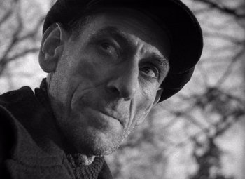 Movie still from “The Third Man” (1949), directed by Carol Reed – An older man wearing a hat and looking at the camera; Close Up shot, Low angle