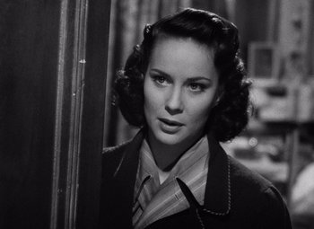 Movie still from “The Third Man” (1949), directed by Carol Reed – A black - and - white photo of a woman in a suit; Close Up shot, Over the shoulder angle