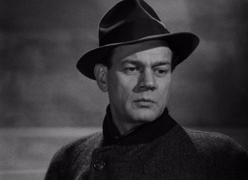 Movie still from “The Third Man” (1949), directed by Carol Reed – A man wearing a hat and a jacket; Close Up shot, Low angle