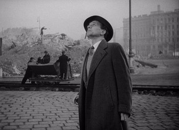 Movie still from “The Third Man” (1949), directed by Carol Reed – An old photo of a man smoking a cigarette; Medium shot, Low angle