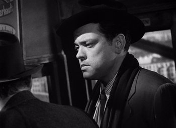 Movie still from “The Third Man” (1949), directed by Carol Reed – A black and white photo of a man wearing a hat; Close Up shot, Over the shoulder angle