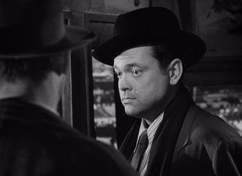 Movie still from “The Third Man” (1949), directed by Carol Reed – A black and white photo of a man wearing a hat; Close Up shot, Over the shoulder angle