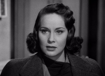 Movie still from “The Third Man” (1949), directed by Carol Reed – A black and white photo of a woman with a black jacket; Close Up shot, Over the shoulder angle