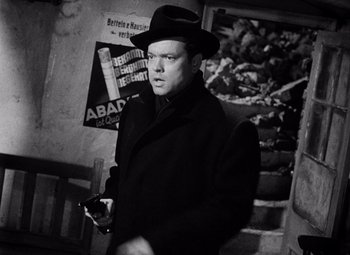 Movie still from “The Third Man” (1949), directed by Carol Reed – A black and white photo of a man in a hat; Medium shot, Low angle
