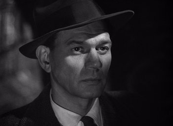 Movie still from “The Third Man” (1949), directed by Carol Reed – A black and white photo of a man wearing a hat; Close Up shot, Low angle