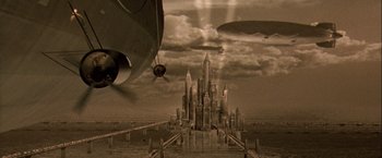 Movie still from “The Thirteenth Floor” (1999), directed by Josef Rusnak – An airplane flying over a large city in a cloudy sky; Extreme Wide shot, High angle