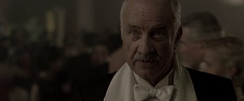 Movie still from “The Thirteenth Floor” (1999), directed by Josef Rusnak – An older man wearing a white bow tie; Close Up shot, Low angle