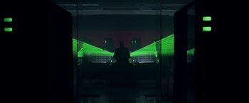 Movie still from “The Thirteenth Floor” (1999), directed by Josef Rusnak – A man standing in front of a window with green lights; Extreme Wide shot, Low angle