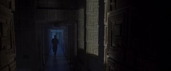 Movie still from “The Thirteenth Floor” (1999), directed by Josef Rusnak – A man walking down a dark hallway in a building; Extreme Wide shot, High angle