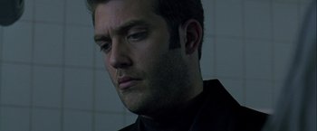 Movie still from “The Thirteenth Floor” (1999), directed by Josef Rusnak – A person wearing a black shirt; Close Up shot, Low angle