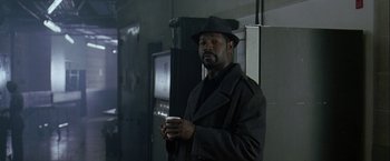 Movie still from “The Thirteenth Floor” (1999), directed by Josef Rusnak – A man holding a coffee cup in a dark room; Medium shot, Over the shoulder angle