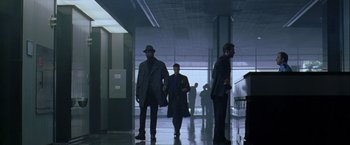 Movie still from “The Thirteenth Floor” (1999), directed by Josef Rusnak – A group of men walking down a hall way; Wide shot, Low angle
