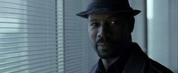 Movie still from “The Thirteenth Floor” (1999), directed by Josef Rusnak – A man wearing a hat and a suit; Close Up shot, Low angle