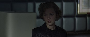 Movie still from “The Thirteenth Floor” (1999), directed by Josef Rusnak – A young woman in a black jacket is standing in a dark room; Close Up shot, Low angle