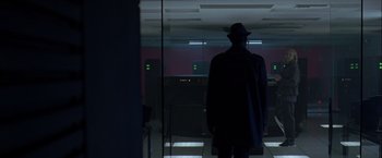 Movie still from “The Thirteenth Floor” (1999), directed by Josef Rusnak – A man wearing a hat standing in front of a window; Wide shot, Low angle