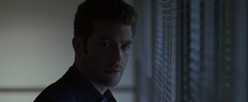 Movie still from “The Thirteenth Floor” (1999), directed by Josef Rusnak – A person wearing a black shirt; Close Up shot, Low angle