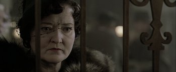 Movie still from “The Thirteenth Floor” (1999), directed by Josef Rusnak – An older woman wearing a fur coat looking at the camera; Close Up shot, Low angle