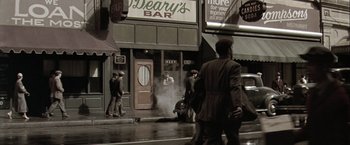 Movie still from “The Thirteenth Floor” (1999), directed by Josef Rusnak – A group of people standing on the side of a street; Wide shot, High angle