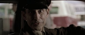 Movie still from “The Thirteenth Floor” (1999), directed by Josef Rusnak – A person wearing a hat; Close Up shot, Low angle