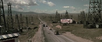 Movie still from “The Thirteenth Floor” (1999), directed by Josef Rusnak – An oil field is shown in the middle of the desert; Extreme Wide shot, High angle