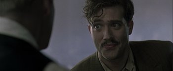 Movie still from “The Thirteenth Floor” (1999), directed by Josef Rusnak – A person looking at the camera; Close Up shot, Over the shoulder angle