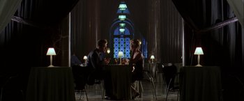 Movie still from “The Thirteenth Floor” (1999), directed by Josef Rusnak – A man and a woman are sitting at a table; Wide shot, High angle