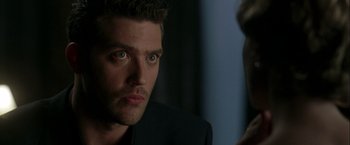 Movie still from “The Thirteenth Floor” (1999), directed by Josef Rusnak – A man that is looking at a woman; Close Up shot, Over the shoulder angle