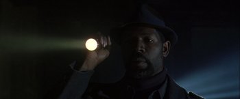 Movie still from “The Thirteenth Floor” (1999), directed by Josef Rusnak – A man holding a flashlight in the dark; Close Up shot, Low angle