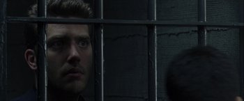 Movie still from “The Thirteenth Floor” (1999), directed by Josef Rusnak – A person behind a fence; Close Up shot, Over the shoulder angle