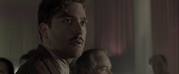 Movie still from “The Thirteenth Floor” (1999), directed by Josef Rusnak – A person with a mustache; Close Up shot, Low angle