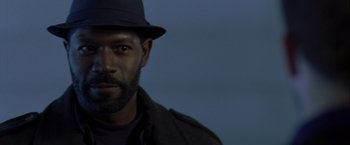 Movie still from “The Thirteenth Floor” (1999), directed by Josef Rusnak – A person wearing a hat; Close Up shot, Low angle