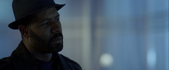 Movie still from “The Thirteenth Floor” (1999), directed by Josef Rusnak – A person wearing a hat; Close Up shot, Over the shoulder angle