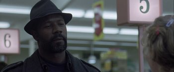 Movie still from “The Thirteenth Floor” (1999), directed by Josef Rusnak – A man with a hat and a beard looking to his left; Close Up shot, Over the shoulder angle