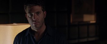 Movie still from “The Thirteenth Floor” (1999), directed by Josef Rusnak – A person in a dark room; Close Up shot, Over the shoulder angle