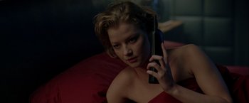 Movie still from “The Thirteenth Floor” (1999), directed by Josef Rusnak – A woman holding a cell phone up to her ear; Close Up shot, Low angle