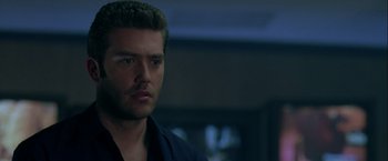 Movie still from “The Thirteenth Floor” (1999), directed by Josef Rusnak – A person wearing a black shirt; Close Up shot, Low angle