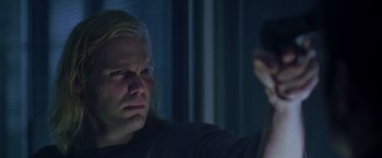 Movie still from “The Thirteenth Floor” (1999), directed by Josef Rusnak – A man with long blonde hair looking into a mirror; Close Up shot, Low angle