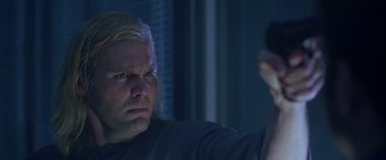 Movie still from “The Thirteenth Floor” (1999), directed by Josef Rusnak – A man with blonde hair is holding a remote control; Close Up shot, Low angle
