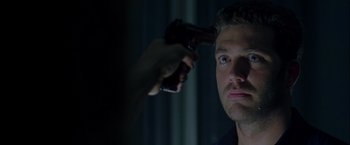 Movie still from “The Thirteenth Floor” (1999), directed by Josef Rusnak – A person holding a gun up to a man's face; Close Up shot, Over the shoulder angle