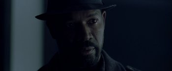 Movie still from “The Thirteenth Floor” (1999), directed by Josef Rusnak – A man wearing a hat is looking at the camera; Close Up shot, Over the shoulder angle