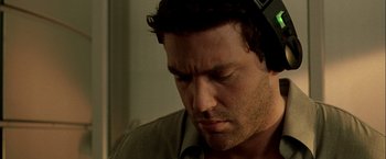 Movie still from “The Thirteenth Floor” (1999), directed by Josef Rusnak – A person wearing headphones; Close Up shot, Low angle